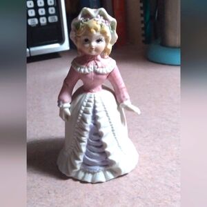 Porcelain girl with bell